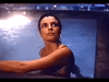 A woman in a swimsuit clings to the pool edge at night, lit by dim reflections, her worried gaze evoking the suspense of Murder in Texas (1981) DVD.