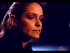 A woman with pulled-back hair and a serious expression is seen close-up against a dark, blurred background, reflecting the intensity of Murder in Texas (1981) DVD—a rare true crime drama movie prized by collectors.