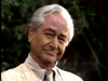 An elderly man with white hair in a light suit and tie smiles at the camera amid blurred greenery—capturing timeless moments ideal for fans of "Father Knows Best Reunion (1977)" on DVD.