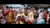 A lively group of villagers in colorful, old-fashioned Scottish attire gather outdoors, smiling and chatting by thatched cottages, reminiscent of scenes from rare classic films like Brigadoon (1954) DVD.