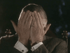 An older man in a suit covers his face with both hands, revealing a gold ring and a watch. The scene captures the tense mood of the World War II historical drama Countdown to War (1989) DVD.