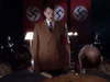 A man dressed as Adolf Hitler stands before two seated people, with Nazi flags behind them. The somber, lamp-lit scene evokes a WWII drama reminiscent of Ian McKellen in Countdown to War (1989) DVD.