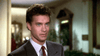 A man with curly brown hair in a gray suit, white shirt, and red tie stands indoors amid soft light and blurred greenery, evoking the classic movie style of "Nothing in Common (1986)" DVD.