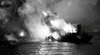 Experience a thrilling WWII submarine battle as an explosion lights up the night near a ship in "Hellcats of the Navy (1957) DVD"—a must-watch for classic movie fans.