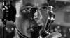 Wearing large headphones, a man speaks intensely into a microphone, echoing the dramatic, vintage style of classic films. The black and white photo captures the timeless feel of "Hellcats of the Navy (1957) DVD.