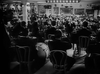 A black-and-white image on the "Stage Door Canteen (1943) DVD" shows a large band performing in an elegant, crowded venue as an eager audience at tables watches, capturing classic wartime musical atmosphere.