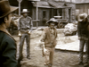 Four men in cowboy hats and Western attire stand in a dusty town, capturing the spirit of 1970s frontier cinema—ideal for fans seeking rare gems like "Gone with the West (1975)" on DVD.