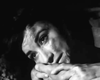 A close-up of a woman's tear-streaked face, full of sadness and vulnerability, evokes classic film style in black-and-white—reminiscent of scenes from the "Guerrilla Girl (1953) DVD.