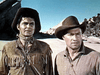 Two men in frontier-style clothing and hats stand outdoors in a rocky landscape under a clear sky, reminiscent of classic western scenes from films like the Kentucky Rifle (1955) DVD.