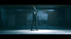 A person stands alone in a dim, empty industrial space, holding orange ribbons above their head under a spotlight—evoking the tension of a military action drama like I Am Soldier (2014) DVD.