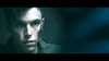 A young man with a red wound on his cheek and a serious look stands in shadows, wearing a green jacket, capturing the tense mood of military action in "I Am Soldier (2014) DVD.