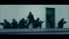 In this scene from the "I Am Soldier (2014) DVD," six armed figures in tactical gear and helmets take cover outside a beige metal building, aiming their weapons and preparing to breach a green door.