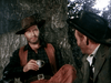Two men in cowboy hats sit by a tree, reminiscing about classic Westerns as one sips from a cup—capture the spirit of such moments with The Lone Gun (1954) DVD.