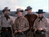 Four men in cowboy hats and western attire stand outdoors before a hilly landscape, evoking the serious, classic frontier mood seen in The Lone Gun (1954) DVD.