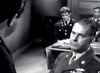 A man in military uniform sits before a tribunal in this black and white WWII drama. Under Fire (1957) DVD is a rare, hard-to-find collectible for classic movie enthusiasts. Two others observe from the background.