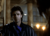 A man with dark hair in a black leather jacket stands indoors with warm lighting and ornate columns, evoking the mysterious style of a vampire detective movie like Nick Knight (1989) DVD.