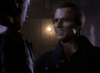 Two men face each other in a moody scene evocative of an 80s vampire detective film. Dramatic lighting intensifies the moment, capturing the essence of "Nick Knight (1989)" on DVD.