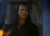 A man with long dark hair and pale skin stands indoors in a black coat and shirt, his fangs visible—capturing the classic vampire detective vibe of the rare 80s film Nick Knight (1989) DVD. The dim background is slightly blurred.