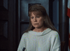 A woman with long light brown hair and bangs in a cream-colored knit sweater sits seriously in court—a key scene from Judgement Day: The Ellie Nesler Story (1999) DVD, part of the rare movies collection.