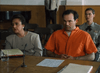 A man in an orange prison jumpsuit sits in a courtroom next to a woman in professional attire, echoing scenes from Judgement Day: The Ellie Nesler Story (1999) DVD—a must-have for collectors of rare true crime movies.