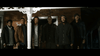 Six men, their faces scarred, stand before a brick building at night in a tense scene from "I'll Take Your Dead (2018) DVD," capturing the intense, raw atmosphere typical of rare Canadian horror thrillers on DVD.