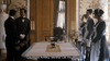 Four servants in black uniforms surround a flower-adorned, white-clothed table in an ornate room—two men on the left, two women on the right. A rare DVD: Madame Nobel (2014), with subtitles for Countess Kinsky, Bertha. Let me through.