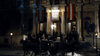 A crowd in formal attire gathers outside a grand building at night, with carriages and Norwegian flags overhead—like a scene from "Madame Nobel (2014)" on DVD. Statues flank the entrance steps beneath "Nobels Freds Pris" banners.