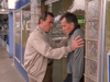 Two men stand outside a storefront in this family drama. One gently presses the other against a glass wall with concern, while the other looks down worried—reminiscent of James Garner in Promise (1986) DVD.