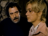 A dark-haired man with a mustache gazes intently at a serious-looking blonde woman in profile; they are indoors against a stone wall—a compelling scene from rare classics like those found in the Winner Take All (1975) DVD, known for its powerful exploration of compulsive gambling drama.