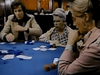 Three people sit around a poker table with cards and poker chips, appearing focused on the game in a scene reminiscent of a compulsive gambling drama. A woman in the background, seated at another table, watches them closely—much like a moment captured from rare classic films or featured on the Winner Take All (1975) DVD.