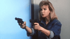 A woman with blonde hair, dressed in a denim jacket, holds two handguns pointed forward with a determined expression—capturing the dynamic style of Hong Kong action comedy classics like City Cops (1989) DVD, a rare movie often sought after by fans.