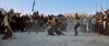 A muscular warrior with long hair fights two armed men in an arena, surrounded by soldiers with shields and spears, under a clear sky—a striking scene reminiscent of a biblical epic or historical drama such as the One Night with the King (2006) DVD.