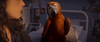 A close-up of a vibrant parrot raising one wing while perched on a bed, with part of a person’s face visible on the left—evoking the whimsical atmosphere found in the “Tuesday (2023) DVD.”.