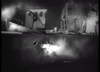 A black-and-white scene depicts a ship struck by explosions at night, with brilliant flashes and smoke pouring from the vessel’s side—capturing the dramatic intensity of naval warfare as seen in *Glory at Sea (1952)*, now available on DVD among classic movies.