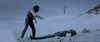 A person stands aiming a pistol at someone lying on sand with a cross on a hill in the background, capturing the dramatic neo-western crime thriller atmosphere of Kill or Be Killed (2015) DVD.