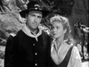 A scene from “Rocky Mountain (1950) DVD” shows a man in a soldier’s uniform and hat standing beside a woman in a blouse, with trees and a horse in the background, all depicted in classic black-and-white reminiscent of a Civil War western.