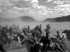 A group of people on horseback ride quickly across a dusty plain under a cloudy sky, with hills visible in the background—perfectly capturing the spirit and dramatic landscapes showcased in the “Rocky Mountain (1950)” DVD, a classic Civil War western.