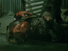 A bloodied person in torn, dirty clothes lies on the ground amid debris and corrugated metal, appearing injured and distressed in a dark, gritty scene reminiscent of the sci-fi horror thriller “Virus (1999)” as depicted on its DVD. The atmosphere suggests violence or the aftermath of an attack.