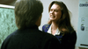 A woman with long brown hair clenches her teeth and appears upset while facing a person with short hair in an indoor setting, evocative of tense confrontations portrayed in the “Stalking Laura (1993) DVD.”.