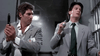 Two men in suits stand tensely inside a building, one gripping a gun and the other clutching a small device, both on high alert as if bracing for an imminent confrontation—perfectly capturing the edge-of-your-seat suspense that makes “The Hidden (1987)” DVD such a beloved gem among rare 1980s sci-fi action thriller collectors.
