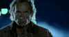 A man with wide eyes and a distressed expression stands in dramatic nighttime lighting, echoing the intense atmosphere of an iconic 1980s horror film, as seen on the “Near Dark (1987) DVD,” with green and blue blurred lights illuminating the background.
