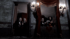 Four people in formal attire sit on two small balconies at night, framed by brick walls and red drapes illuminated by ornate wall lamps. They seem to be clapping or gesturing toward the street below—a striking scene evocative of Roman Polanski’s style, making it a perfect visual for collectors of rare movies like The Tenant (1976) DVD.