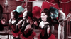Three women in red and black can-can outfits dance with feathered headpieces onstage in a lively saloon, while a man stands behind—ideal for fans of The Last Gun (1964) DVD or collectors of classic western movies.