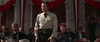 A man wearing a sheriff's badge stands before a decorated building with red, white, and blue bunting, capturing the Western spirit seen in films like Ride A Crooked Trail (1958) DVD.