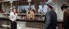 Three men in cowboy attire stand at a saloon bar, watched by a bartender in a tan jacket—capturing the classic Western spirit seen in Ride A Crooked Trail (1958) DVD.