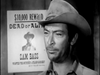 A man in a cowboy hat stands before a wanted poster offering $10,000 for Sam Bass—Dead or Alive. The Slowest Gun in the West (1960) DVD is perfect for fans of classic comedy and western spoof collections.