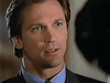 A man in a suit with light eyes and brown hair looks intently at someone out of frame, appearing serious and focused—evoking the timeless charm of *The Counterfeit Contessa (1994)*, now available on DVD for fans of rare, hard-to-find classic movies.