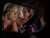 Two women anxiously look through a car window while someone inside points a gun at them. The scene is tense, and the women appear worried and focused on the person holding the weapon—capturing the suspense and drama found in "Breach of Conduct (1994)" on DVD.