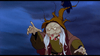 An animated old woman with long white hair, clawed hands, and a pointed brown hat topped by a raven stands against a dark, cloudy background, appearing to cast a spell—evoking the magical and unforgettable characters featured in “The Last Unicorn (1982)” DVD.