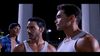 Three men stand outside at night under streetlights. Two, dressed in gray tank tops, look serious and focused, while a third man in a blue plaid shirt and backward cap stands behind them, half hidden in shadow. The tense atmosphere feels like it could be straight out of a martial arts film—perhaps even from Only the Strong (1993), now available on DVD for collectors.